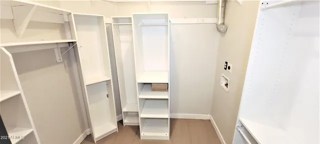 a bathroom with a double vanity sink a mirror and bathtub