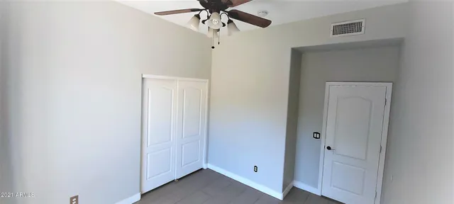 a view of a big room with wooden floor and brick wall