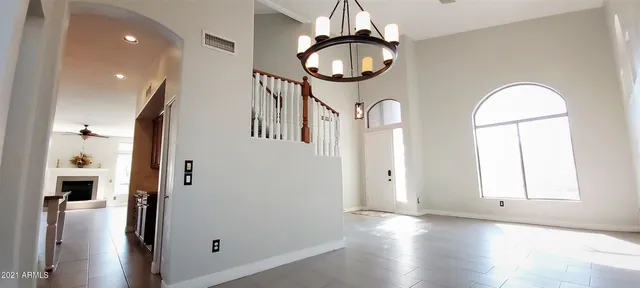 a view of a livingroom with wooden floor and staircase