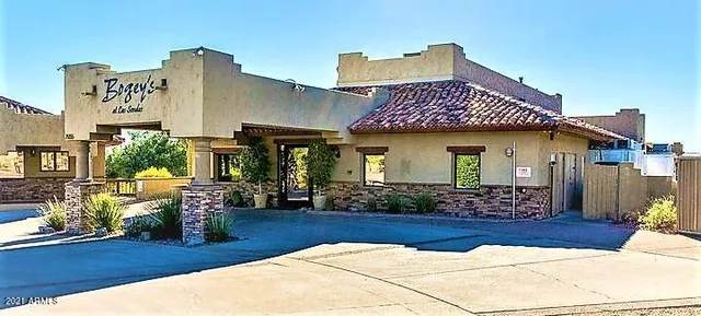 a view of swimming pool with lounge chair and dinning table under an umbrella