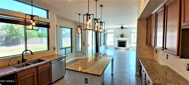 a kitchen with a stove sink and cabinets