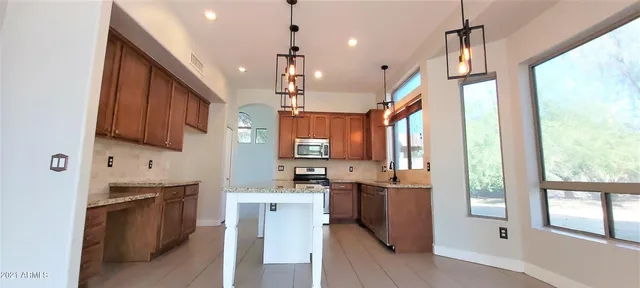 a view of an empty room with a fireplace and a window