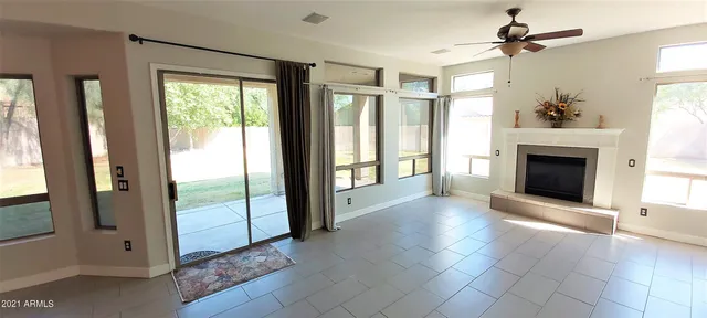 a view of a porch with wooden floor and a fireplace