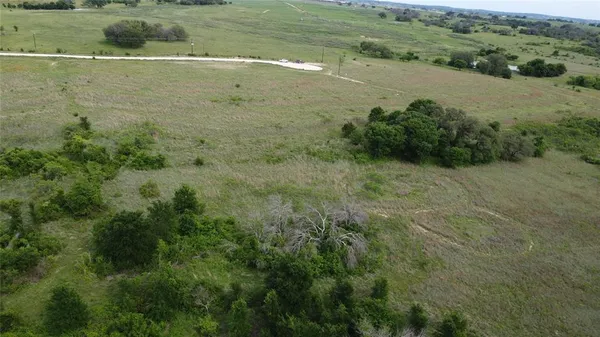 a view of a field with an ocean