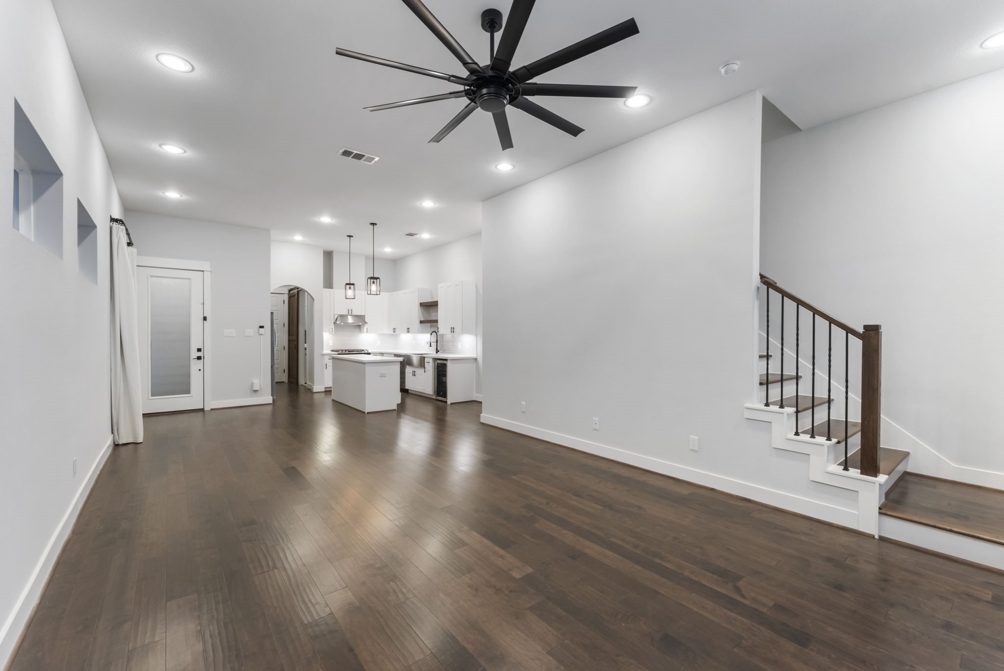 113 Coronado Street Houston, TX 77009 - Photo 13 of 39 a view of an empty room and kitchen with window wooden floor