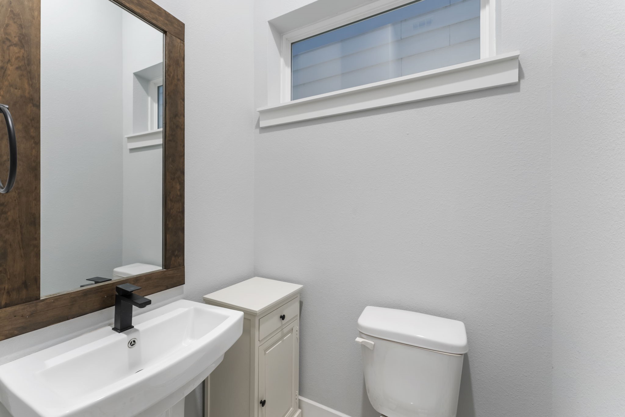 113 Coronado Street Houston, TX 77009 - Photo 16 of 39 a bathroom with a sink a toilet and mirror