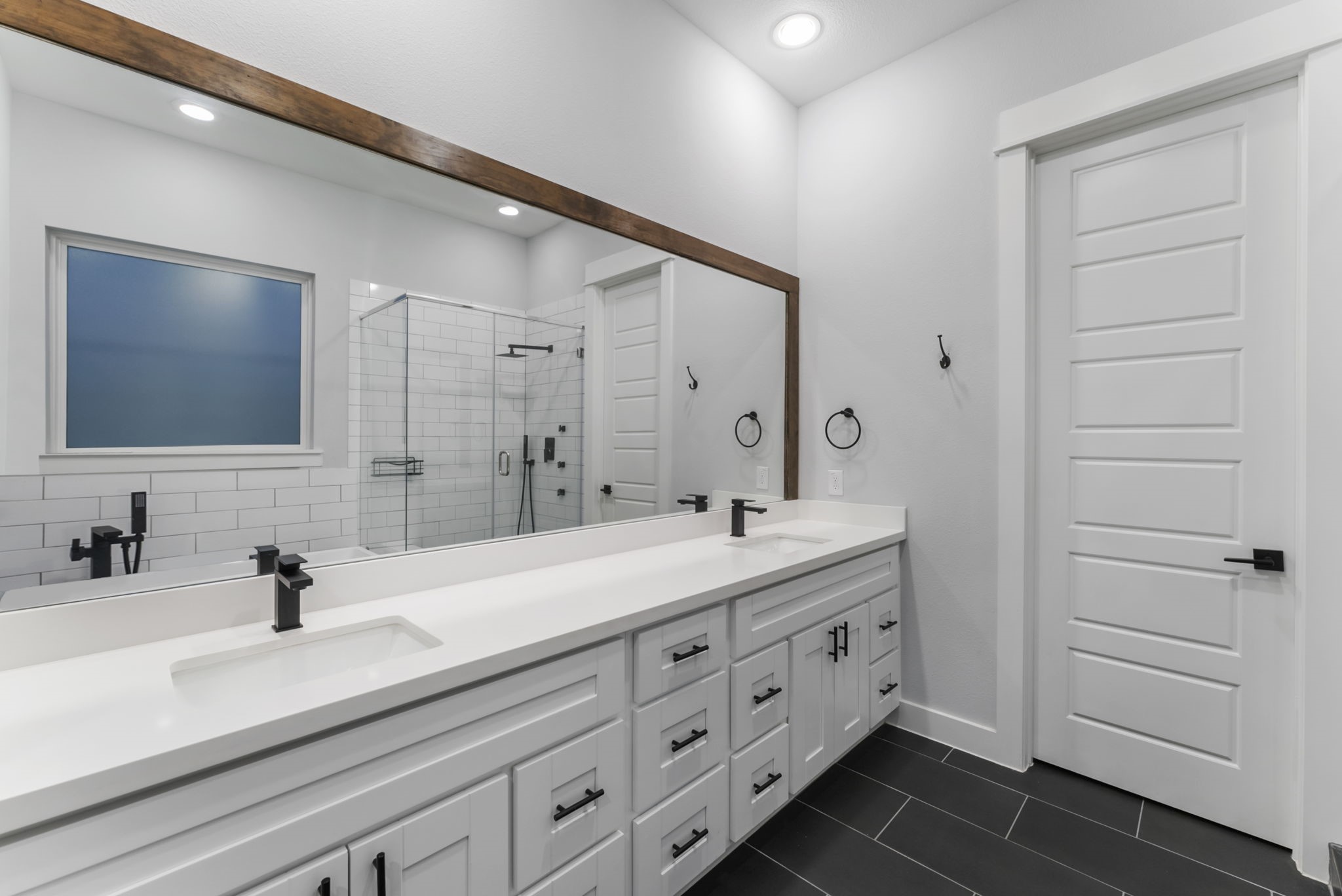 113 Coronado Street Houston, TX 77009 - Photo 23 of 39 a bathroom with a double vanity sink and mirror
