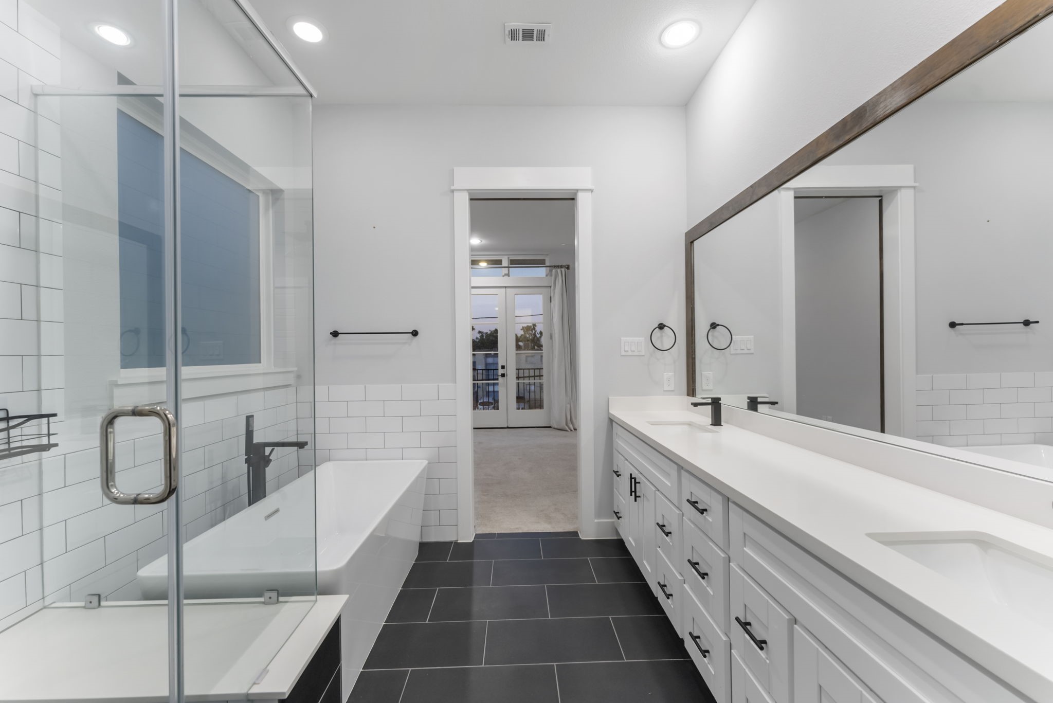 113 Coronado Street Houston, TX 77009 - Photo 24 of 39 a spacious bathroom with a double vanity sink a large mirror and a shower