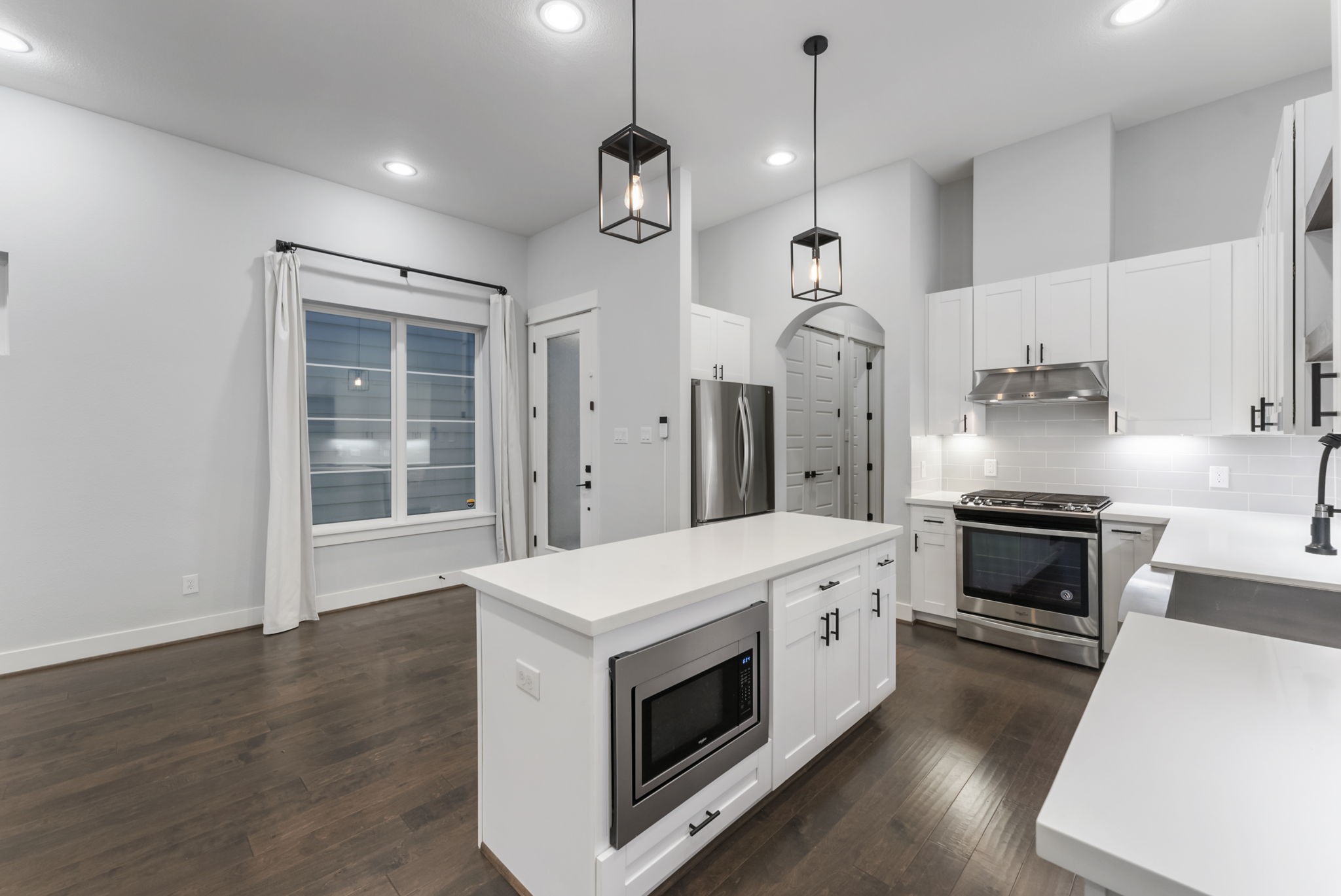 113 Coronado Street Houston, TX 77009 - Photo 8 of 39 a open kitchen with a stove a sink and a wooden floor
