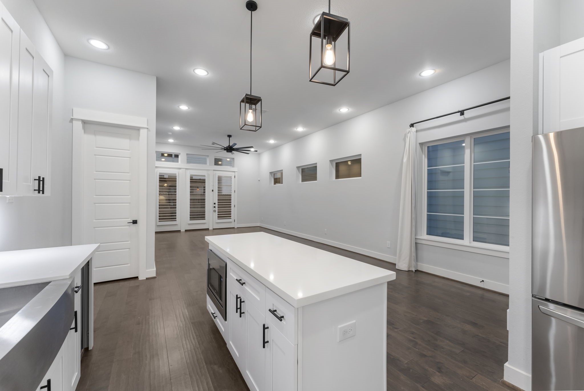113 Coronado Street Houston, TX 77009 - Photo 9 of 39 a kitchen with stainless steel appliances kitchen island hardwood floor and a sink