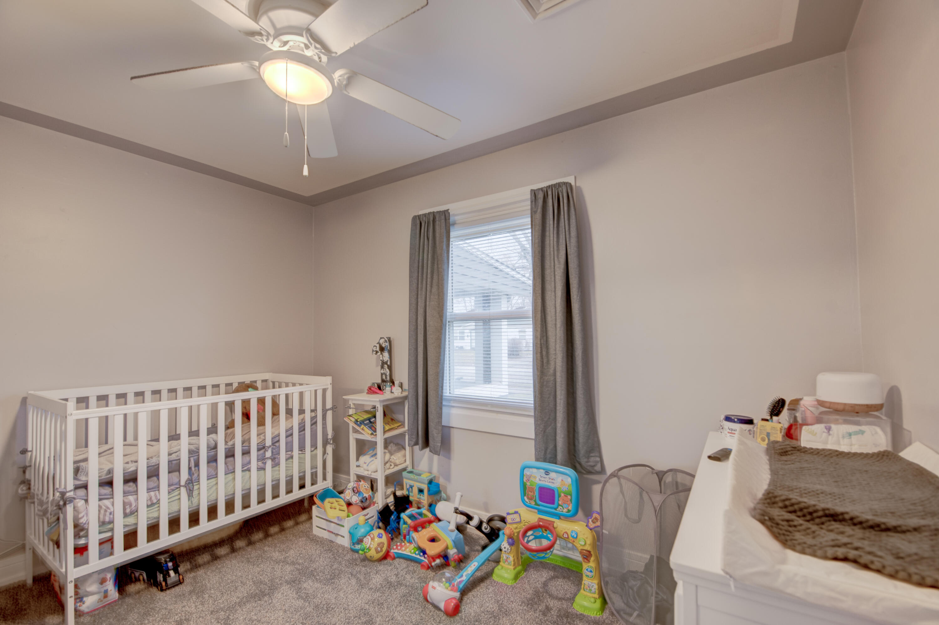 2080 Wright Street Gary, IN 46404 - Photo 14 of 20 a bedroom with a bed and a chandelier