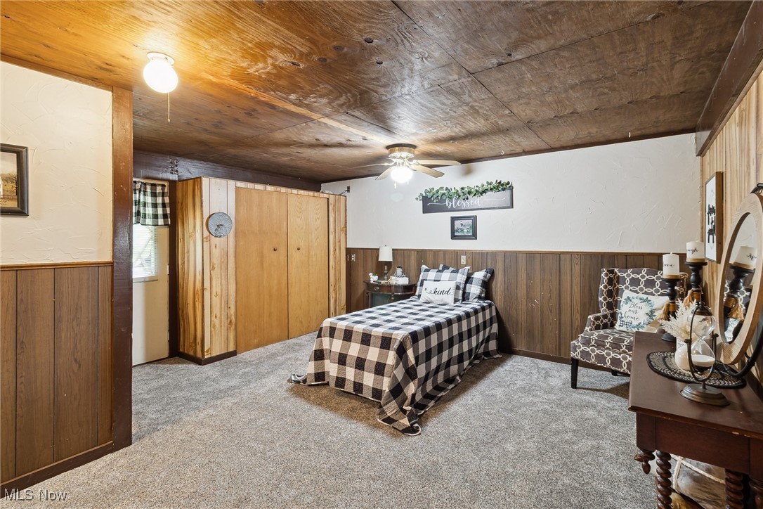 2860 Middle Road Pierpont, OH 44082 - Photo 43 of 50 Bedroom with wood walls, carpet floors, a wainscoted wall, and wood ceiling