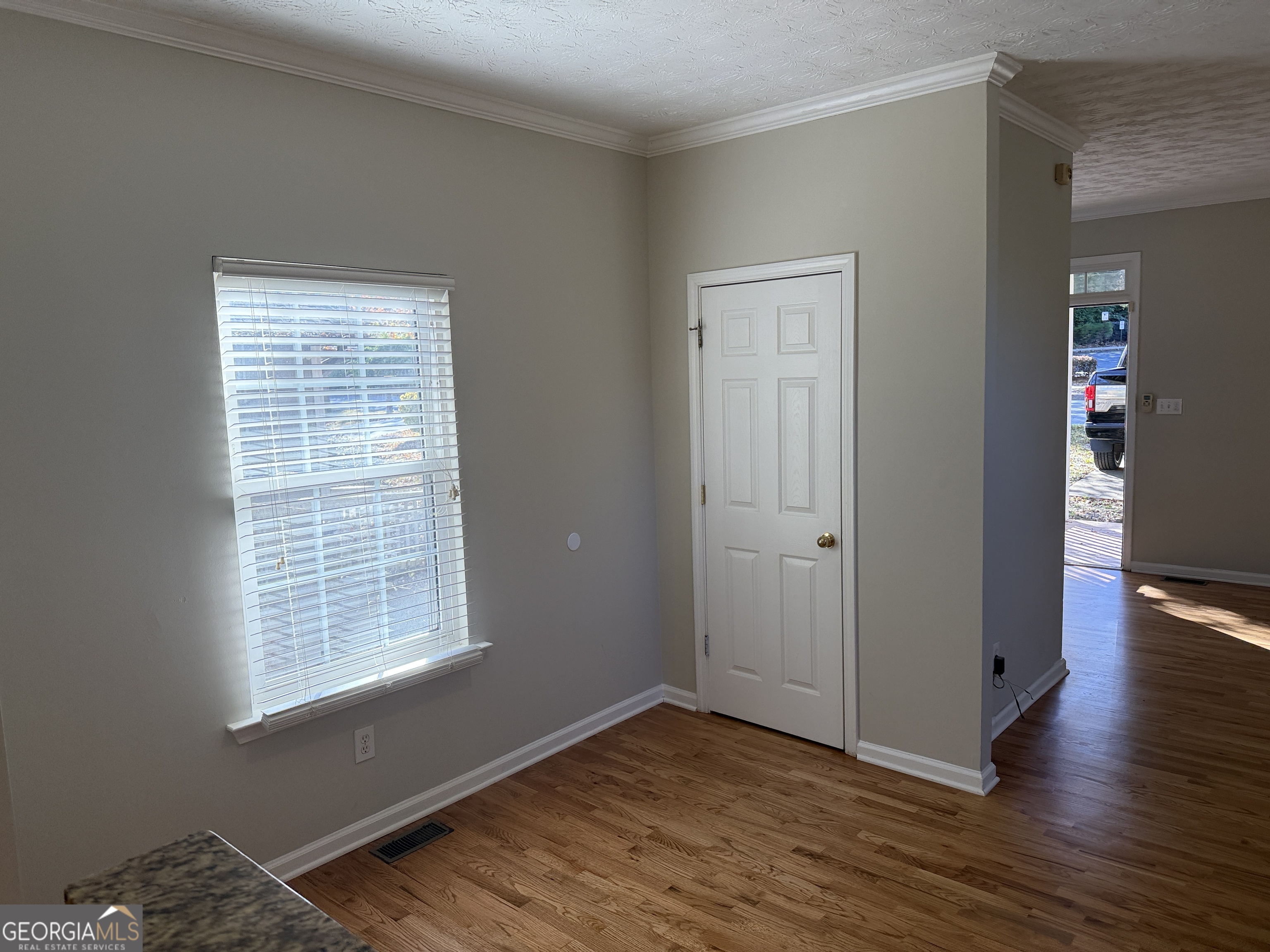 27 Montgomery Street Northeast Atlanta, GA 30307 - Photo 11 of 25 a view of an empty room with wooden floor and a window