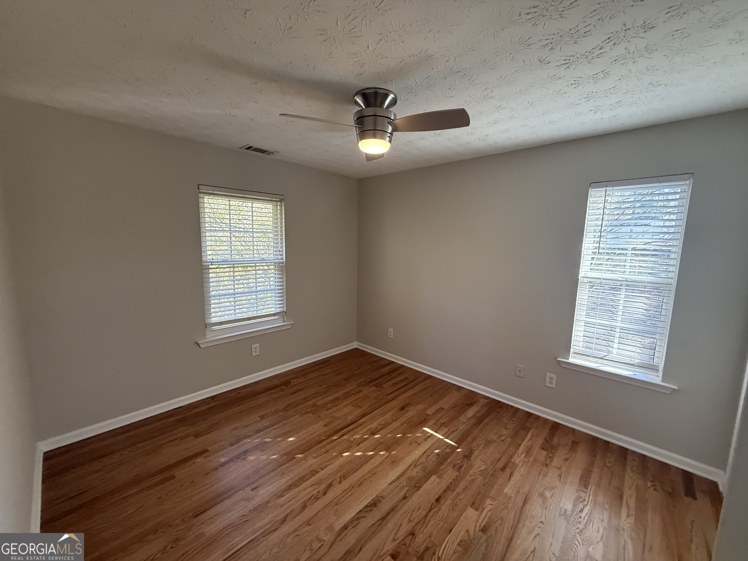 27 Montgomery Street Northeast Atlanta, GA 30307 - Photo 14 of 25 wooden floor in an empty room with a window
