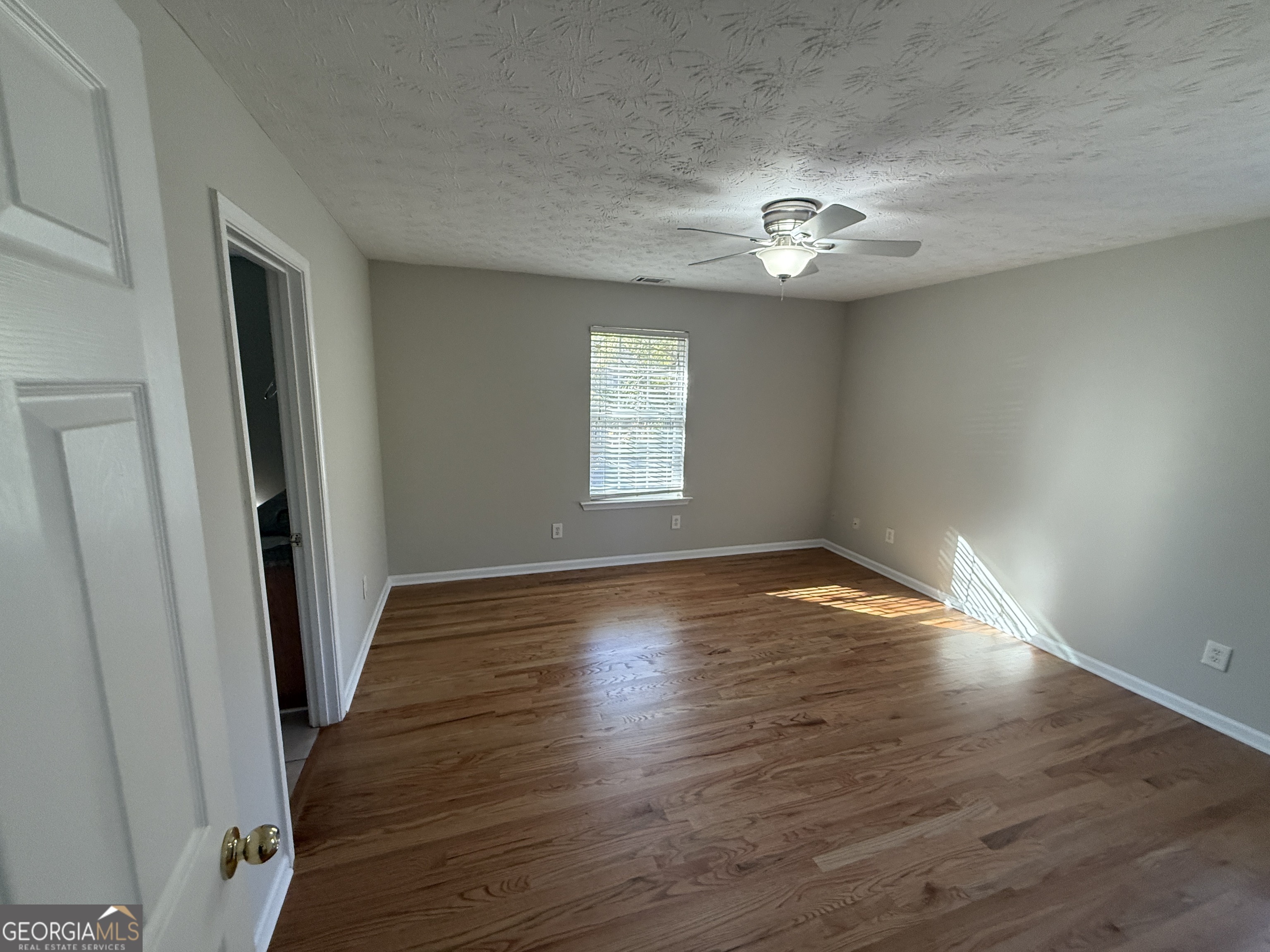 27 Montgomery Street Northeast Atlanta, GA 30307 - Photo 16 of 25 an empty room with wooden floor and windows