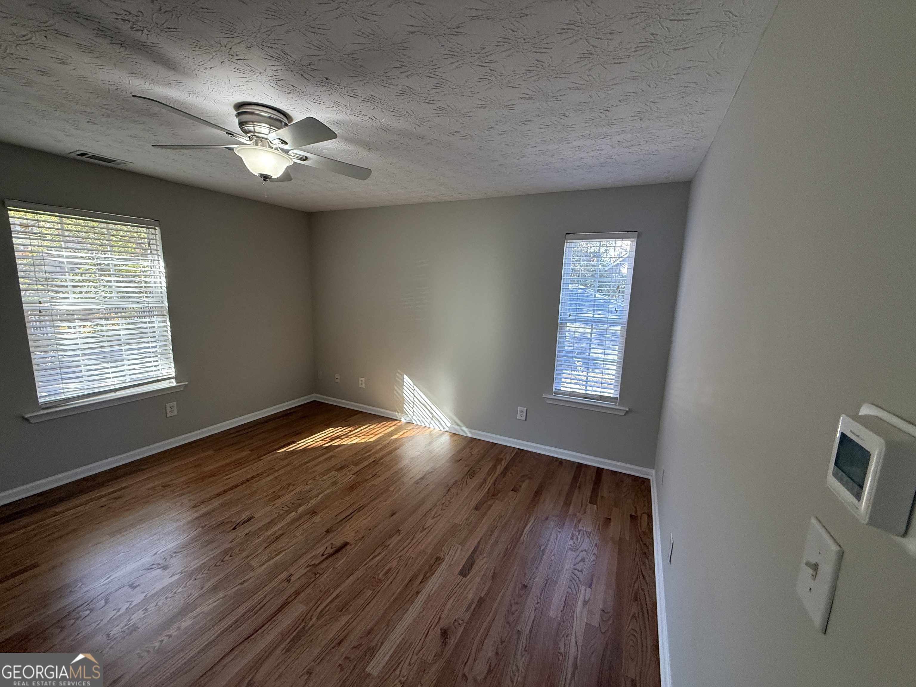27 Montgomery Street Northeast Atlanta, GA 30307 - Photo 17 of 25 a view of an empty room with wooden floor and a window