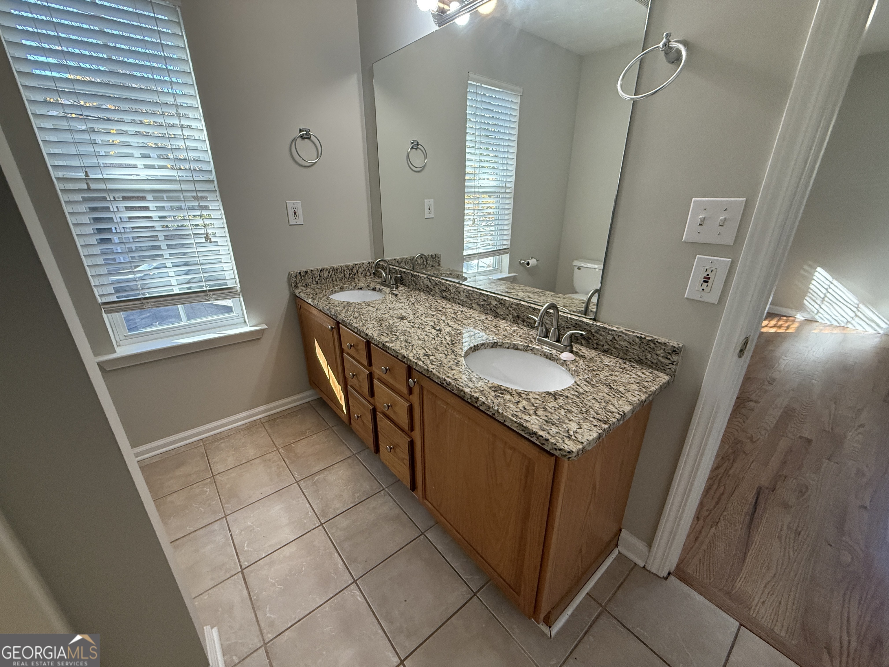 27 Montgomery Street Northeast Atlanta, GA 30307 - Photo 19 of 25 a bathroom with a granite countertop sink a mirror a vanity and a shower
