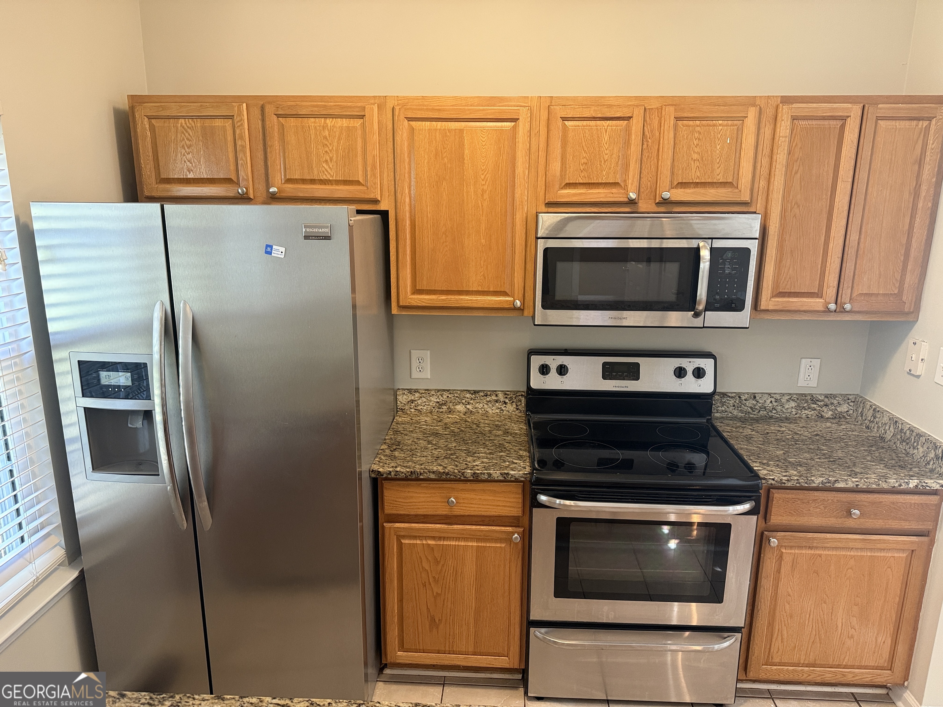 27 Montgomery Street Northeast Atlanta, GA 30307 - Photo 9 of 25 a kitchen with granite countertop a refrigerator stove and microwave
