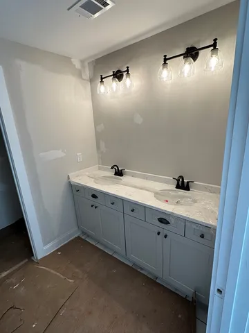 a bathroom with a sink and mirror