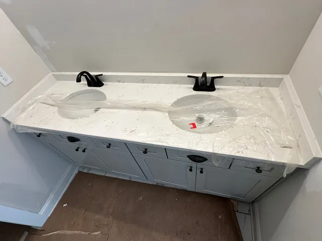 a view of an empty room with wooden floor and a cabinet