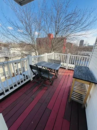 a view of a balcony with wooden benches