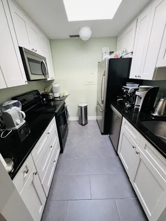a kitchen with a sink stove and refrigerator