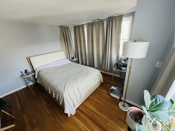 a bedroom with a bed and a window