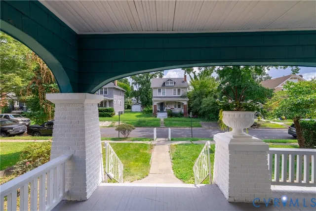 a view of a patio with table and chairs potted plants and a palm tree