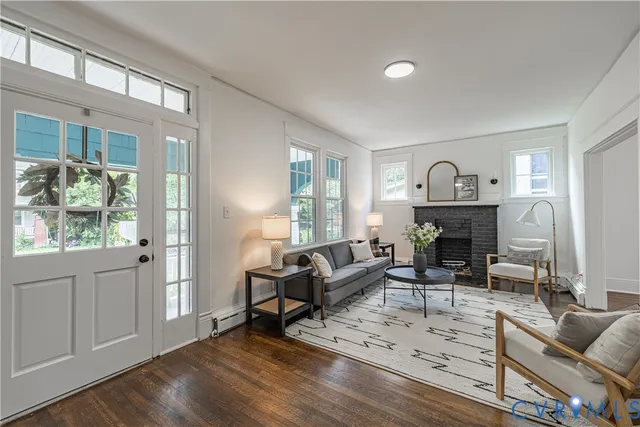 a view of front door with wooden floor and a window