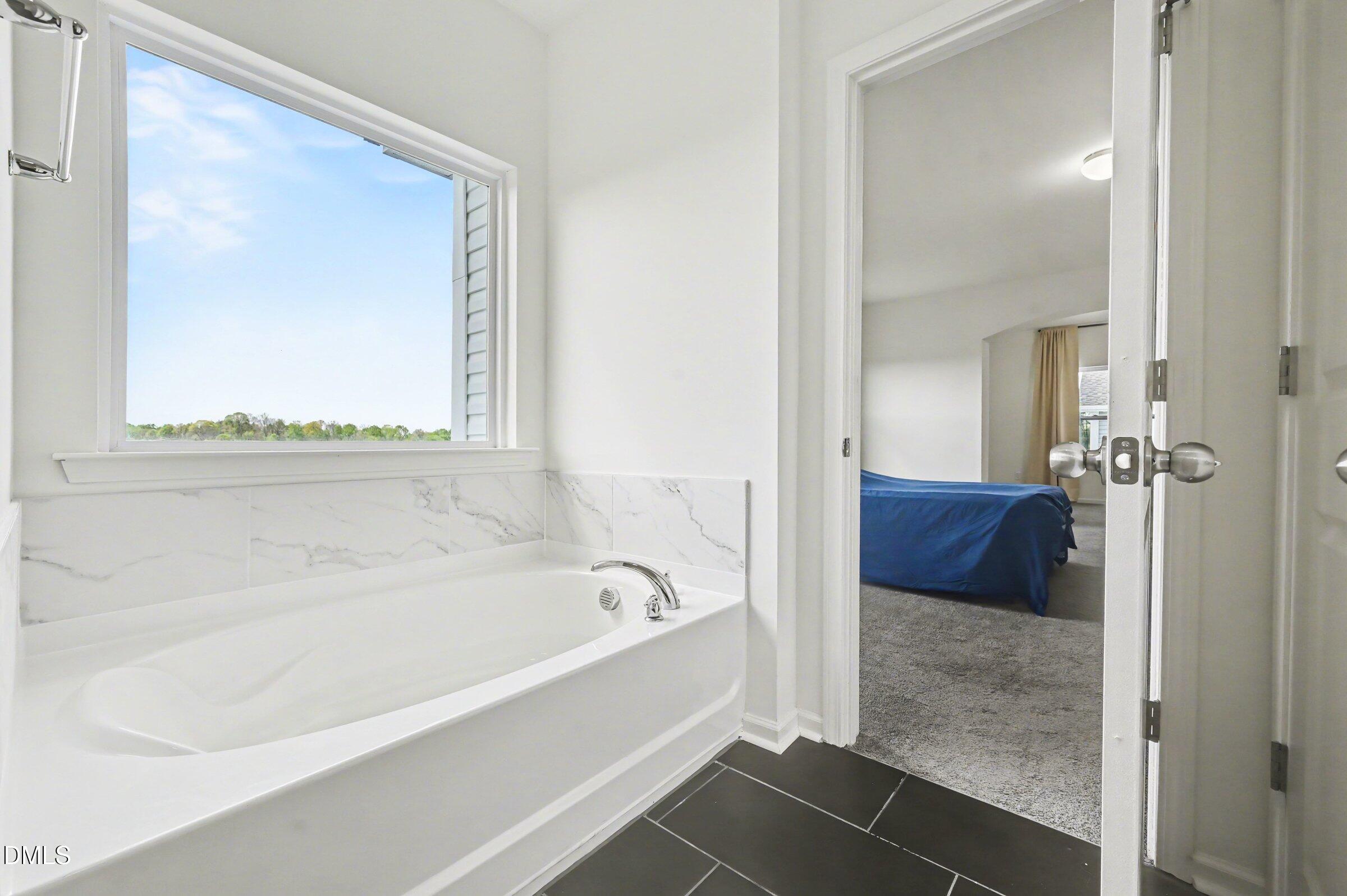 7015 Grainfield Road Mebane, NC 27302 - Photo 31 of 42 a bathroom with a bathtub and a shower