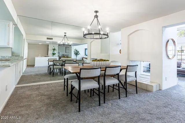 a kitchen with stainless steel appliances granite countertop a sink a counter space and a window