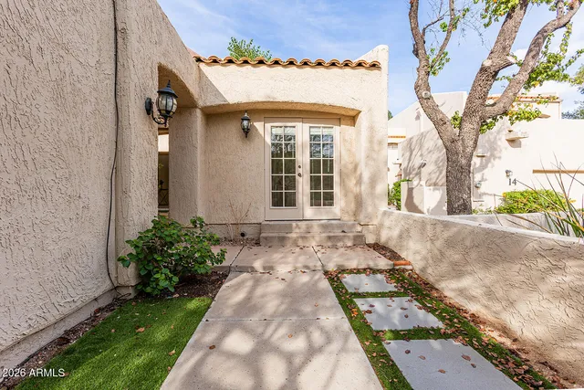 a living room with patio furniture and a large window
