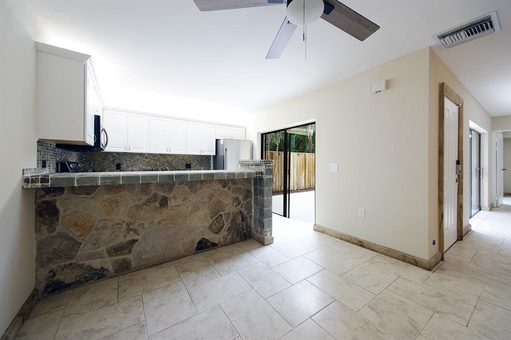 1700 Embassy Drive, Unit 402 West Palm Beach, FL 33401 - Photo 11 of 38 a view of counter top space with refrigerator