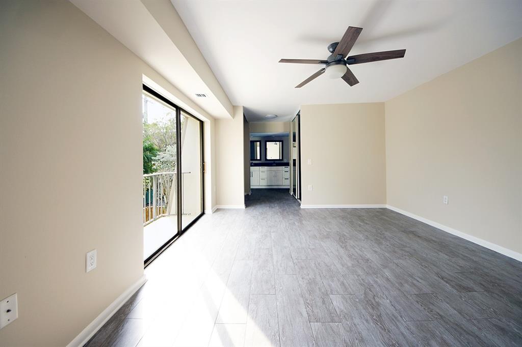 1700 Embassy Drive, Unit 402 West Palm Beach, FL 33401 - Photo 17 of 38 a view of empty room with wooden floor and fan