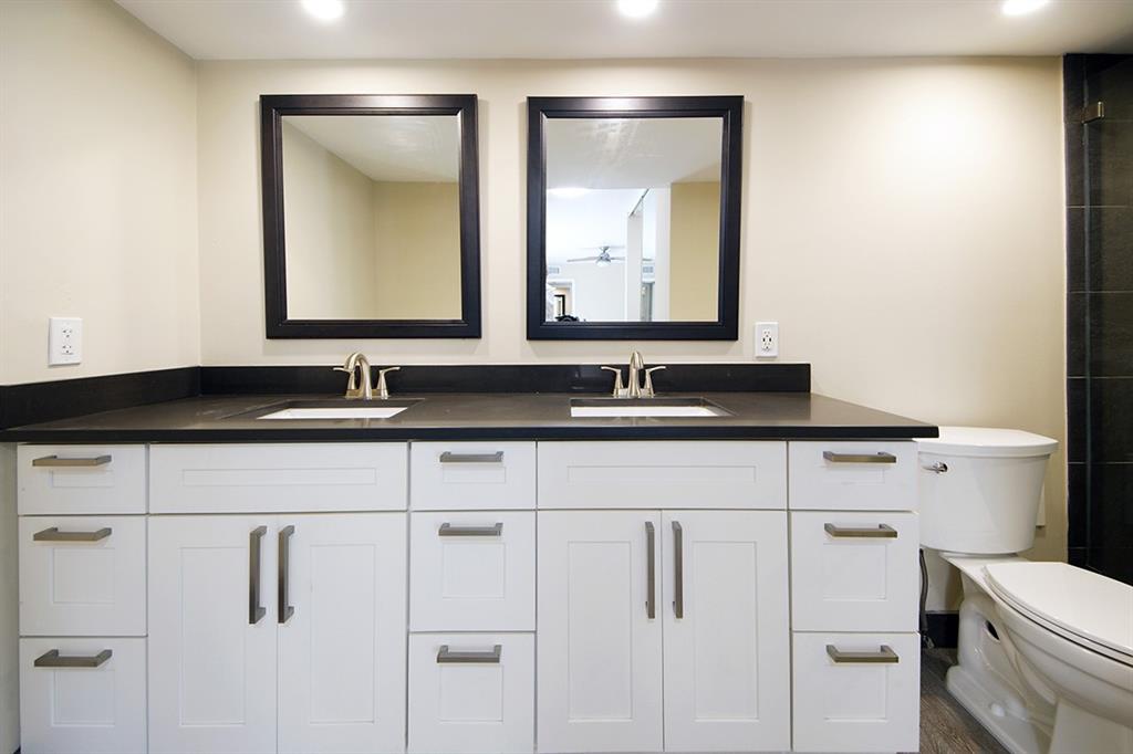 1700 Embassy Drive, Unit 402 West Palm Beach, FL 33401 - Photo 22 of 38 a bathroom with a sink and a mirror
