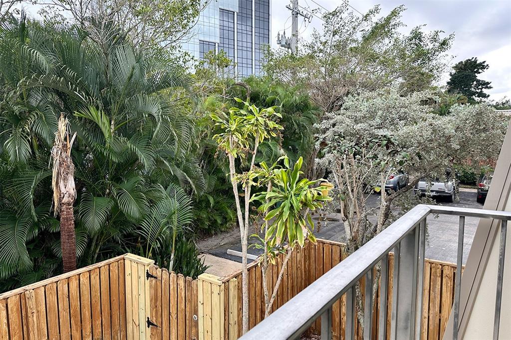 1700 Embassy Drive, Unit 402 West Palm Beach, FL 33401 - Photo 24 of 38 a view of a wooden fence and trees
