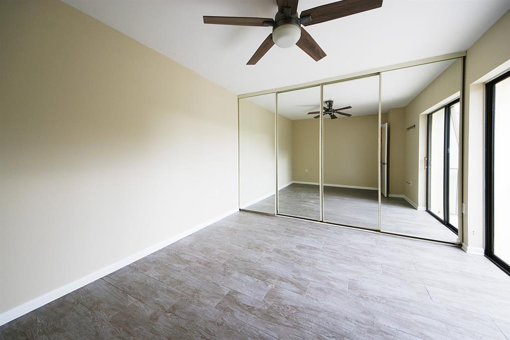 1700 Embassy Drive, Unit 402 West Palm Beach, FL 33401 - Photo 26 of 38 an empty room with a empty space and windows