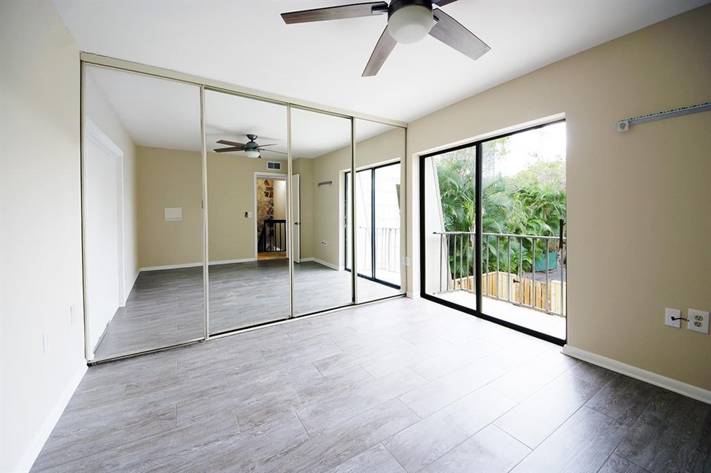 1700 Embassy Drive, Unit 402 West Palm Beach, FL 33401 - Photo 27 of 38 a view of empty room with wooden floor and fan