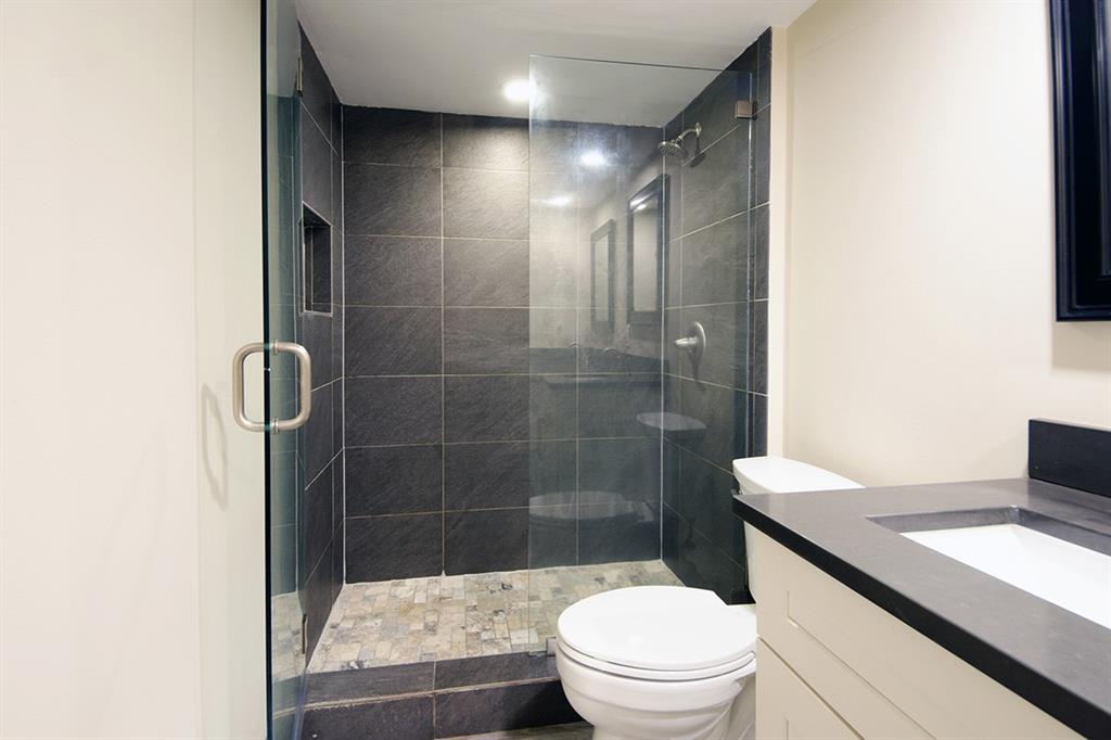 1700 Embassy Drive, Unit 402 West Palm Beach, FL 33401 - Photo 28 of 38 a bathroom with a sink a toilet and shower