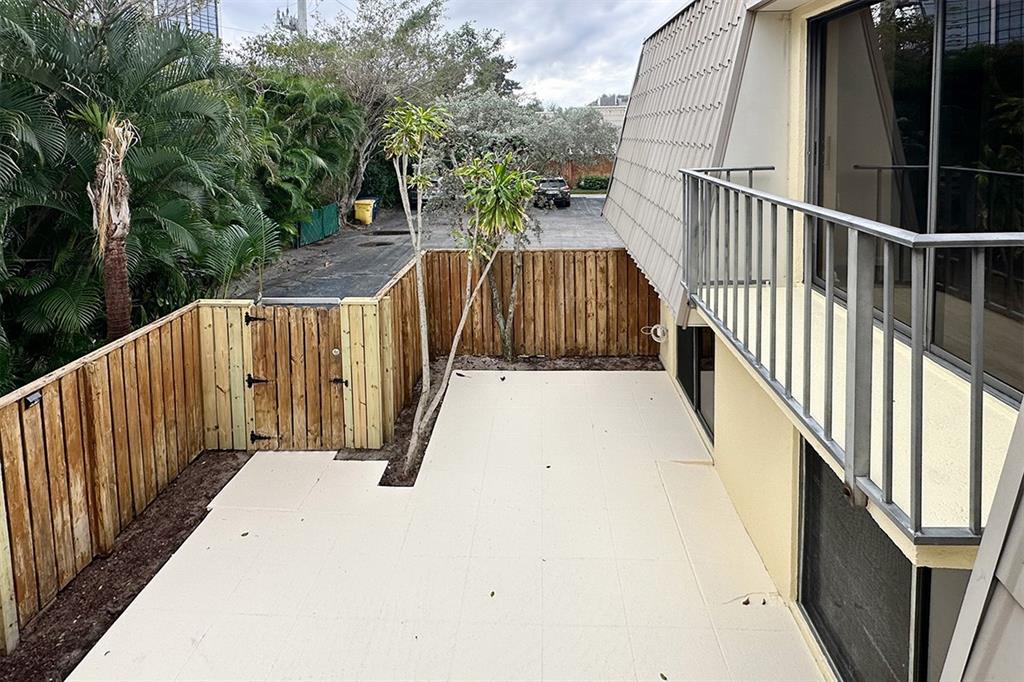 1700 Embassy Drive, Unit 402 West Palm Beach, FL 33401 - Photo 30 of 38 a view of balcony with wooden floor and fence