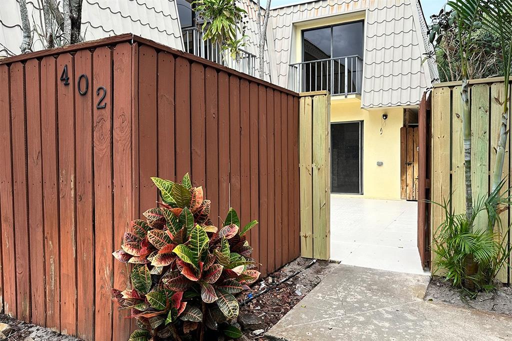 1700 Embassy Drive, Unit 402 West Palm Beach, FL 33401 - Photo 31 of 38 a view of a house with backyard and sitting area
