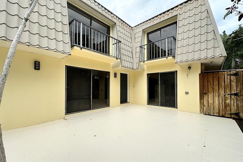 1700 Embassy Drive, Unit 402 West Palm Beach, FL 33401 - Photo 32 of 38 a front view of a house with a garage