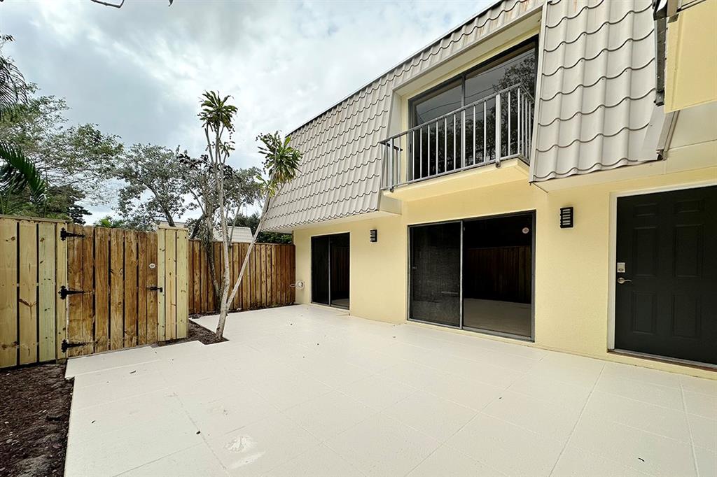 1700 Embassy Drive, Unit 402 West Palm Beach, FL 33401 - Photo 34 of 38 a view of a house with a yard and garage