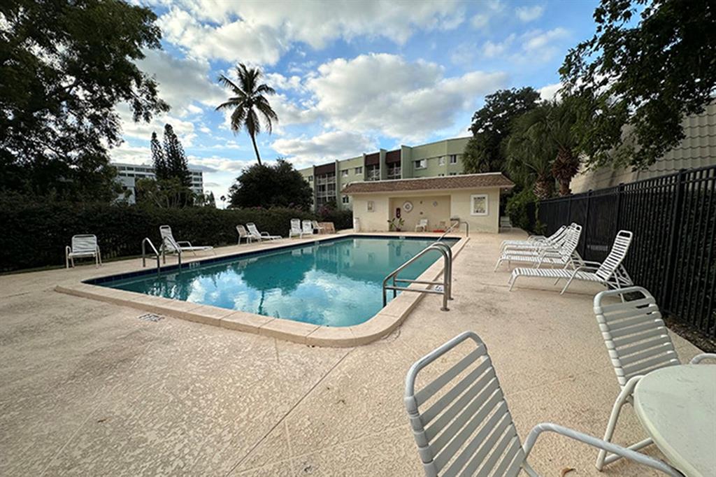 1700 Embassy Drive, Unit 402 West Palm Beach, FL 33401 - Photo 35 of 38 a view of a swimming pool with a patio