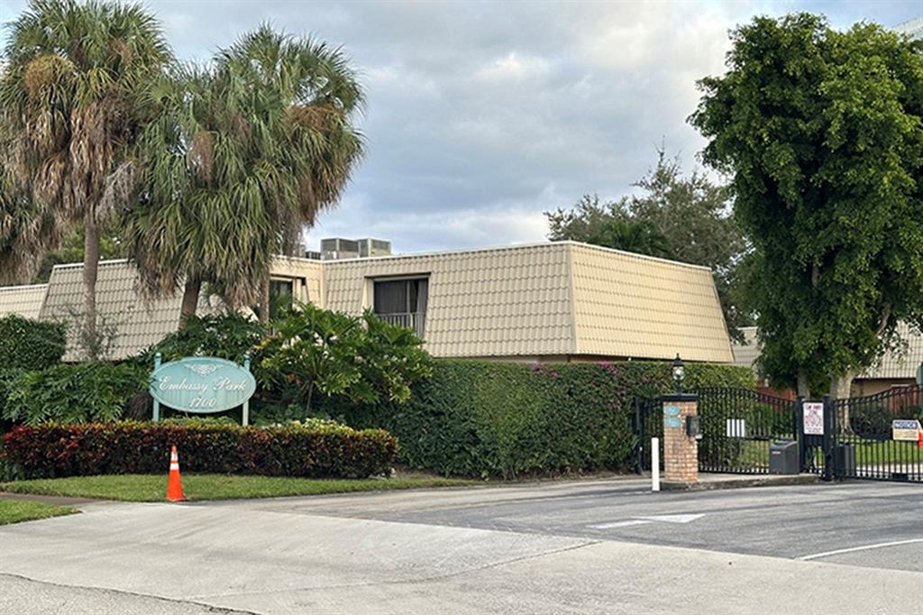 1700 Embassy Drive, Unit 402 West Palm Beach, FL 33401 - Photo 38 of 38 a view of a house with a sink and table under an umbrella