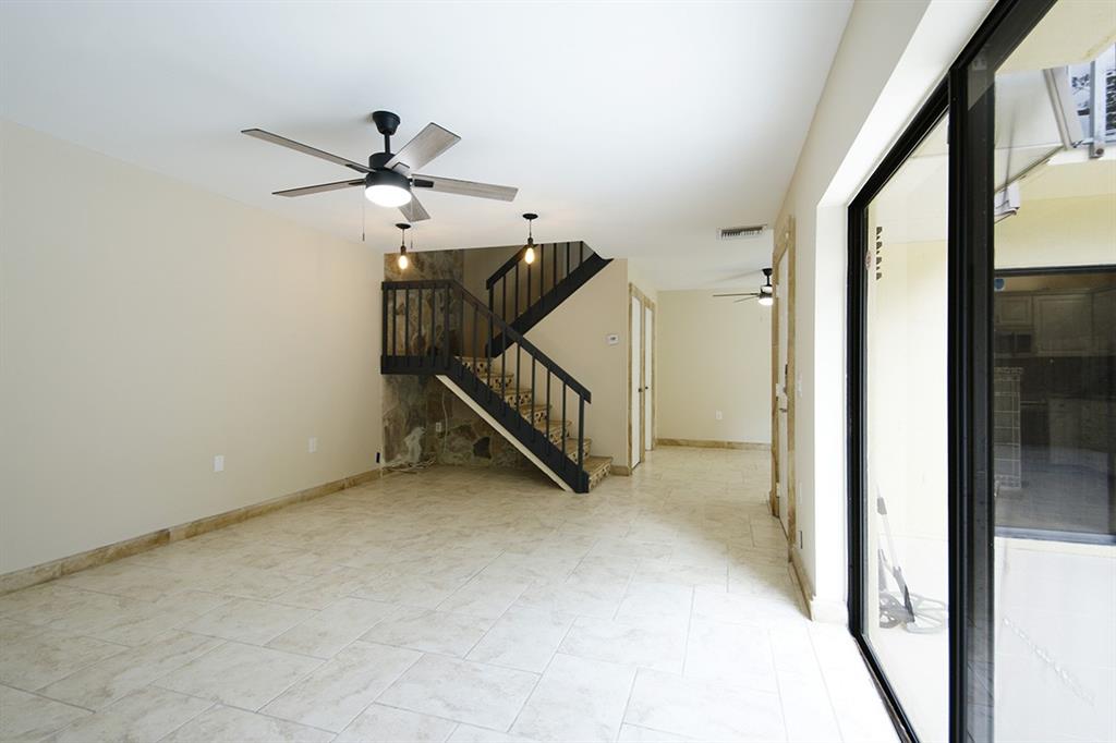 1700 Embassy Drive, Unit 402 West Palm Beach, FL 33401 - Photo 5 of 38 a view of a hallway with staircase