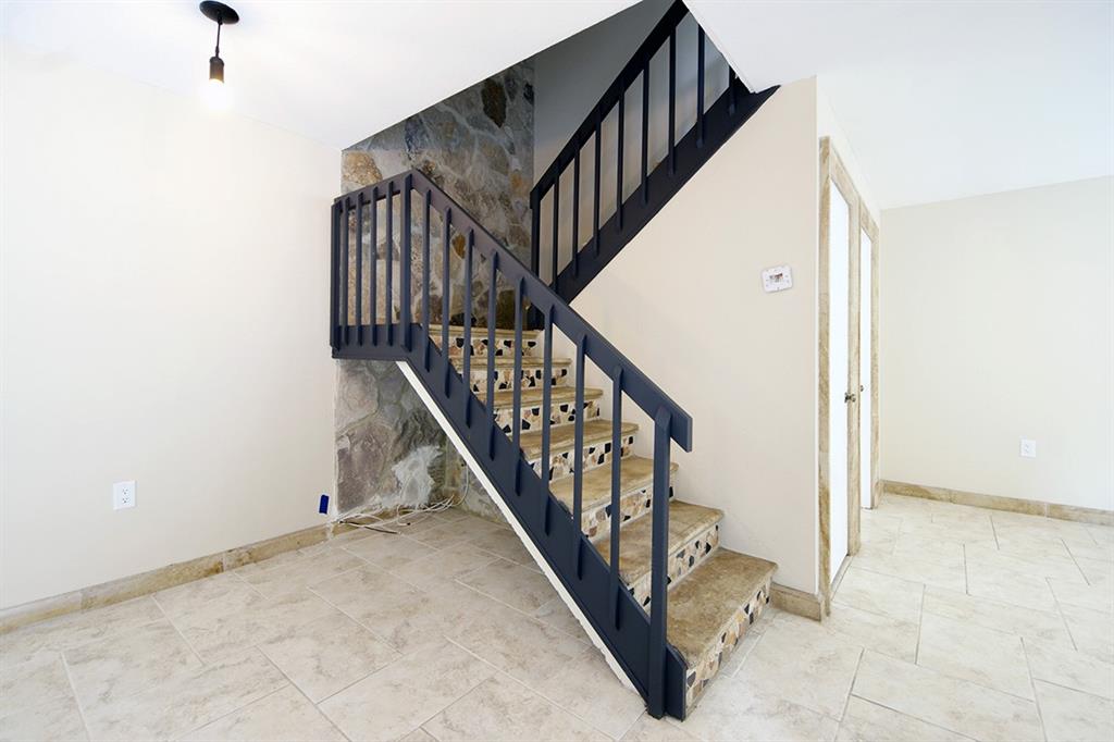 1700 Embassy Drive, Unit 402 West Palm Beach, FL 33401 - Photo 6 of 38 a view of staircase with railing and white walls