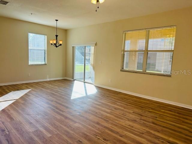 1276 Priory Circle Winter Garden, FL 34787 - Photo 11 of 37 an empty room with wooden floor and windows