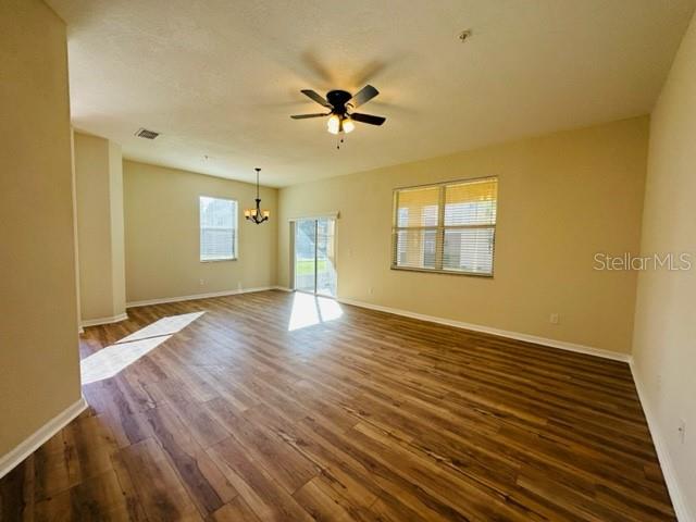 1276 Priory Circle Winter Garden, FL 34787 - Photo 12 of 37 a view of an empty room with a window and wooden floor