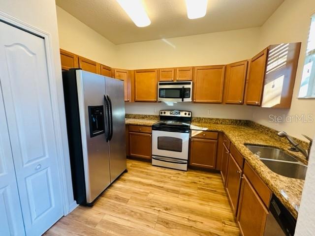 1276 Priory Circle Winter Garden, FL 34787 - Photo 14 of 37 a kitchen with a sink cabinets and stainless steel appliances